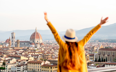 lady happy to be travelling in Florence with arms in the air