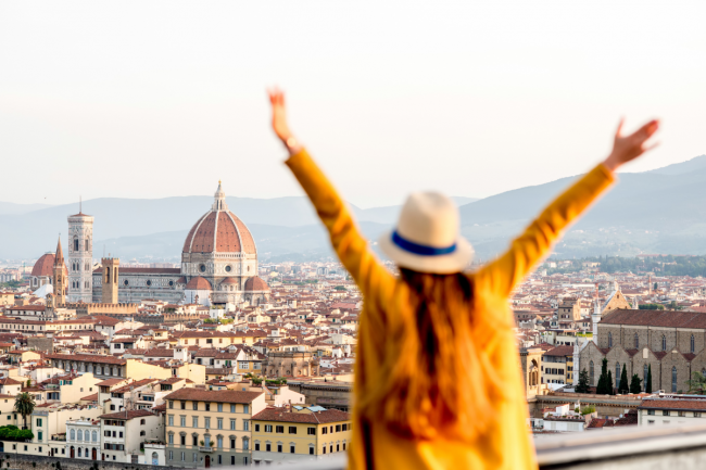 lady happy to be travelling in Florence with arms in the air