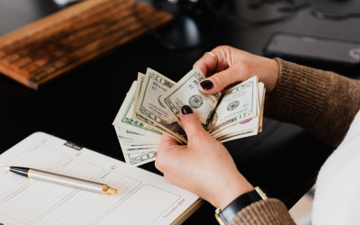 counting USD notes at a desk